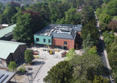 aerial view of new college building surrounded by trees