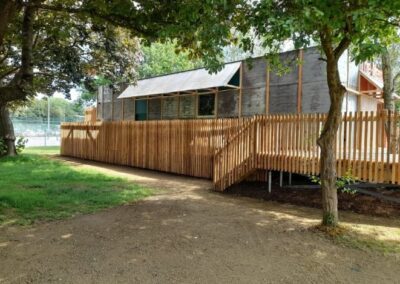 new theatre building with fencing and trees