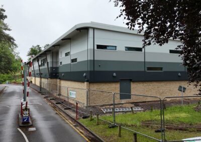 new college building with temporary fencing and access barriers up