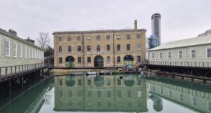 external of dockyard building reflected in water in front
