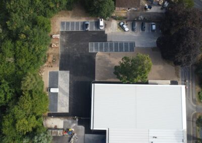 aerial view of new college building surrounded by trees