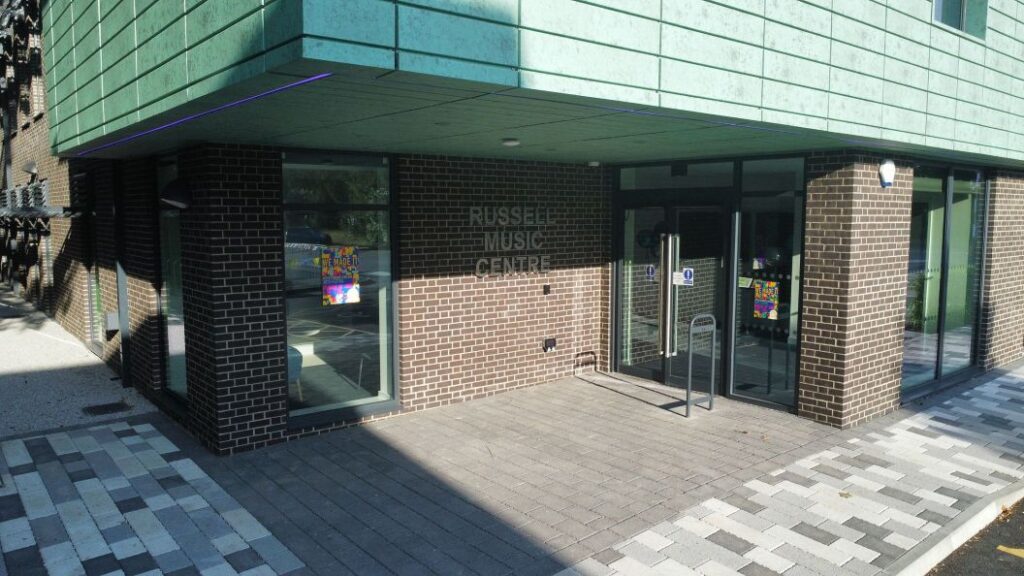 exterior of new building showing name and entrance door