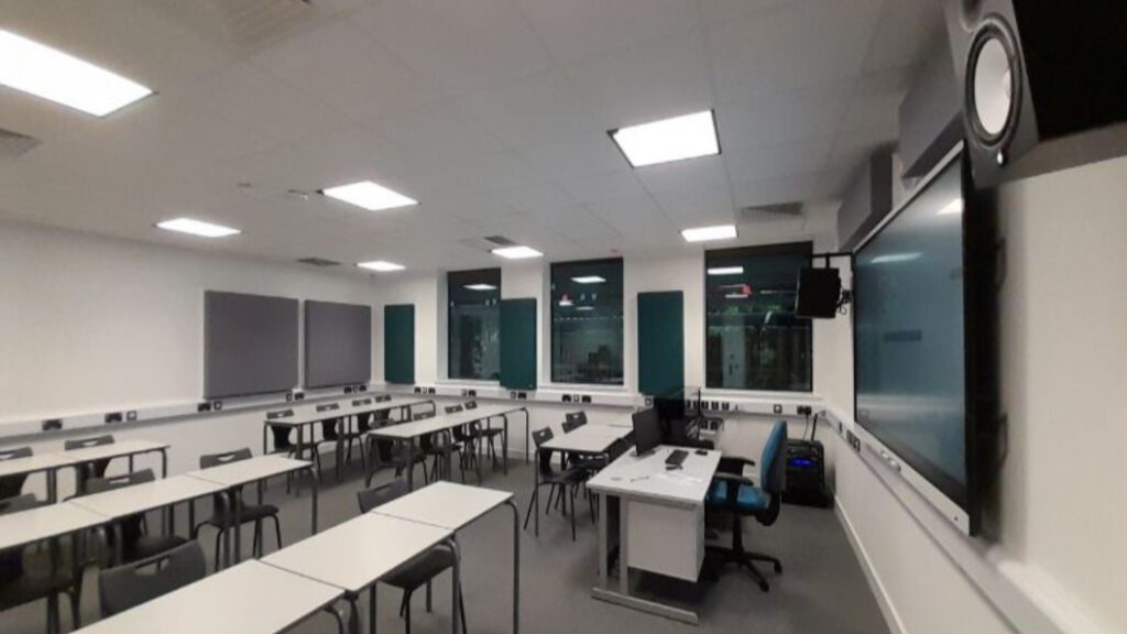 new classroom with chairs and tables in rows