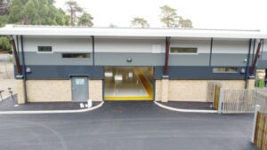 new college building with open bay doors entrance