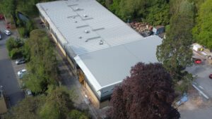 view of new college building from the air surrounded by trees
