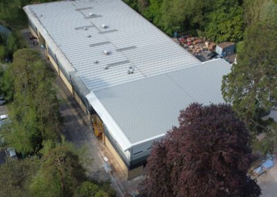 view of new college building from the air surrounded by trees